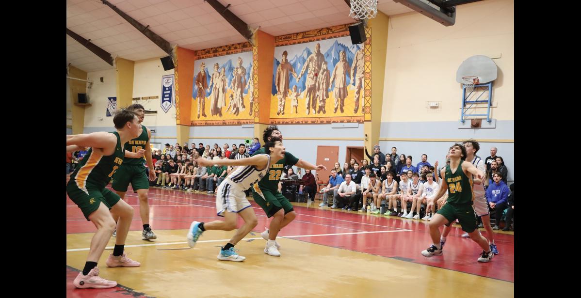 Photo by Anna Lionas HOLD FOR REBOUND- Nanooks and Seahawks alike rush to the basket to get the rebound.