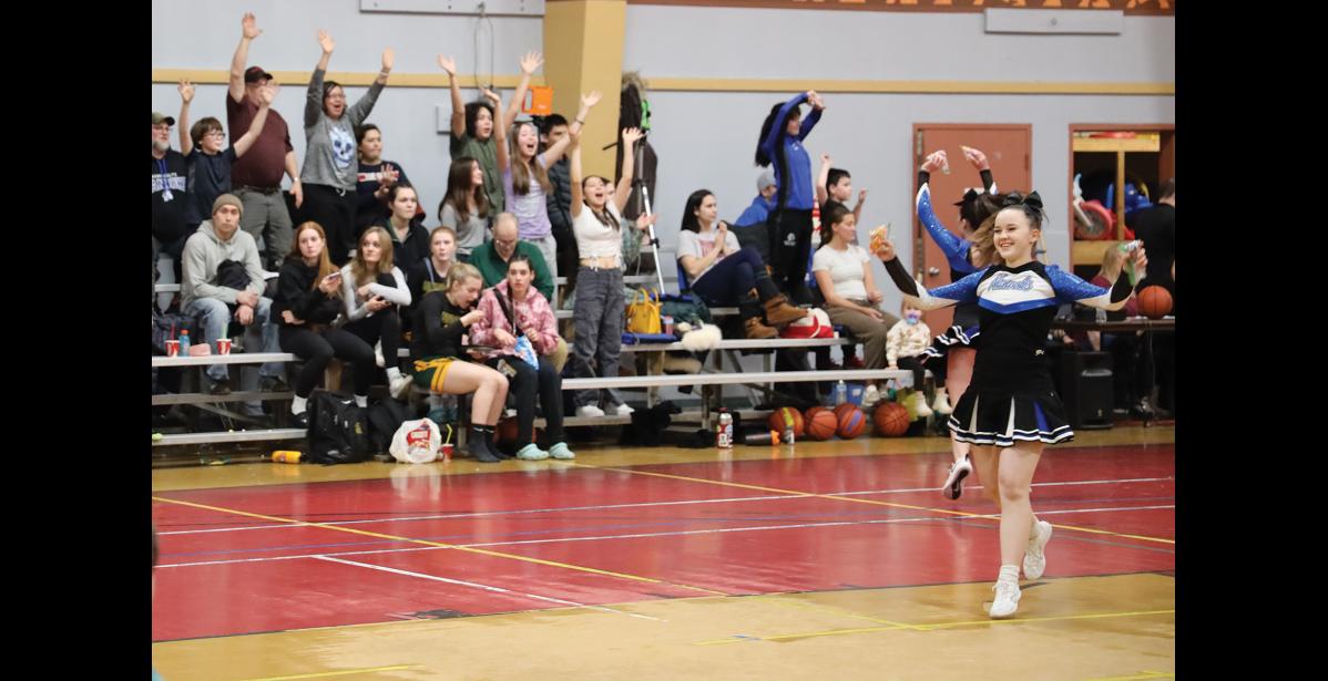 Photo by Anna Lionas ALL SMILES- Cheerleader Kara Johanson runs to throw goodie bags to the crowd attending the Ruckus at the Rec games.