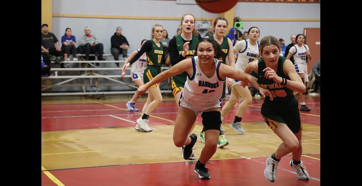 Photo by Anna Lionas COMING AT YOU—Nome Nanook Jocelyn Nichols-Takak and Seward Seahawk Ava Jagielski race to grab a ball that’s flying out of bounds, during the Ruckus at the Rec tournament on Saturday, January 20.