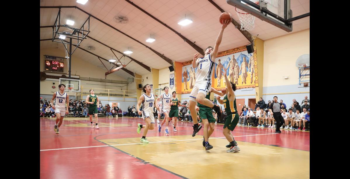 Photo by Anna Lionas REVERSE- Finn Gregg scores points with a reverse layup.