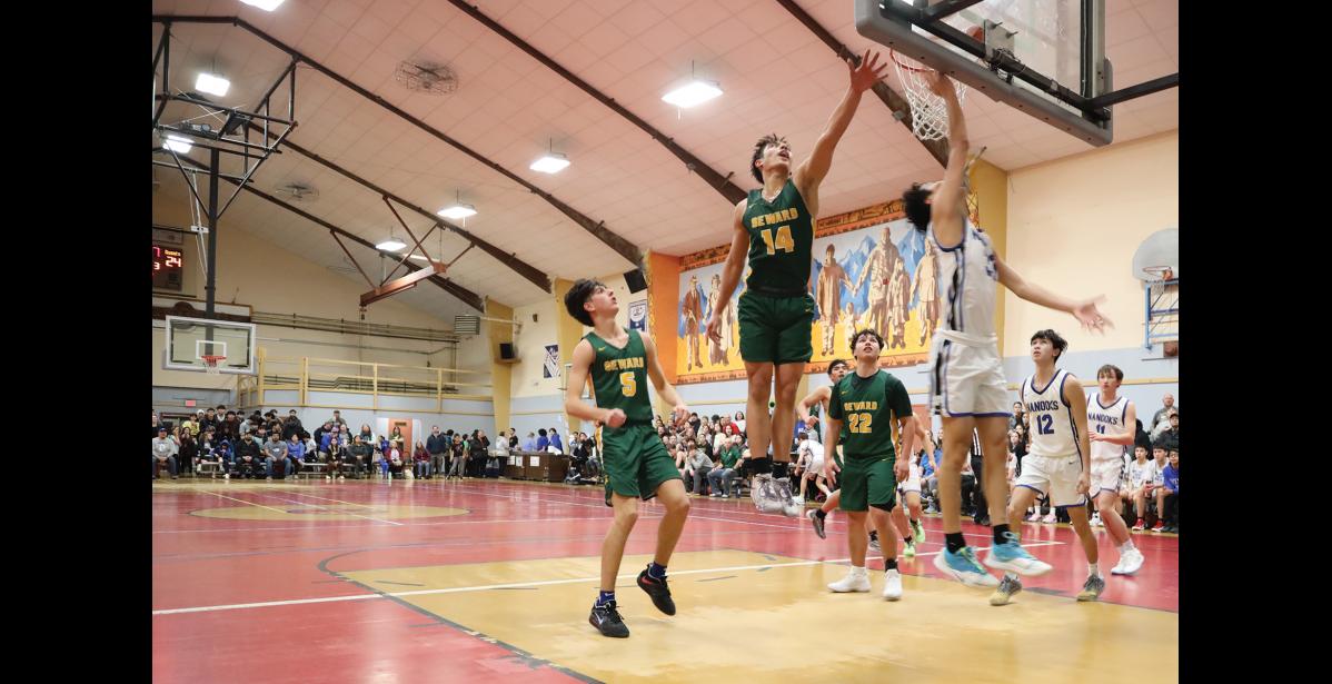 Photo by Anna Lionas HOPS- Seahawk Ben Ambrosiani reaches up to block Nanook Rochard Cross’ layup.
