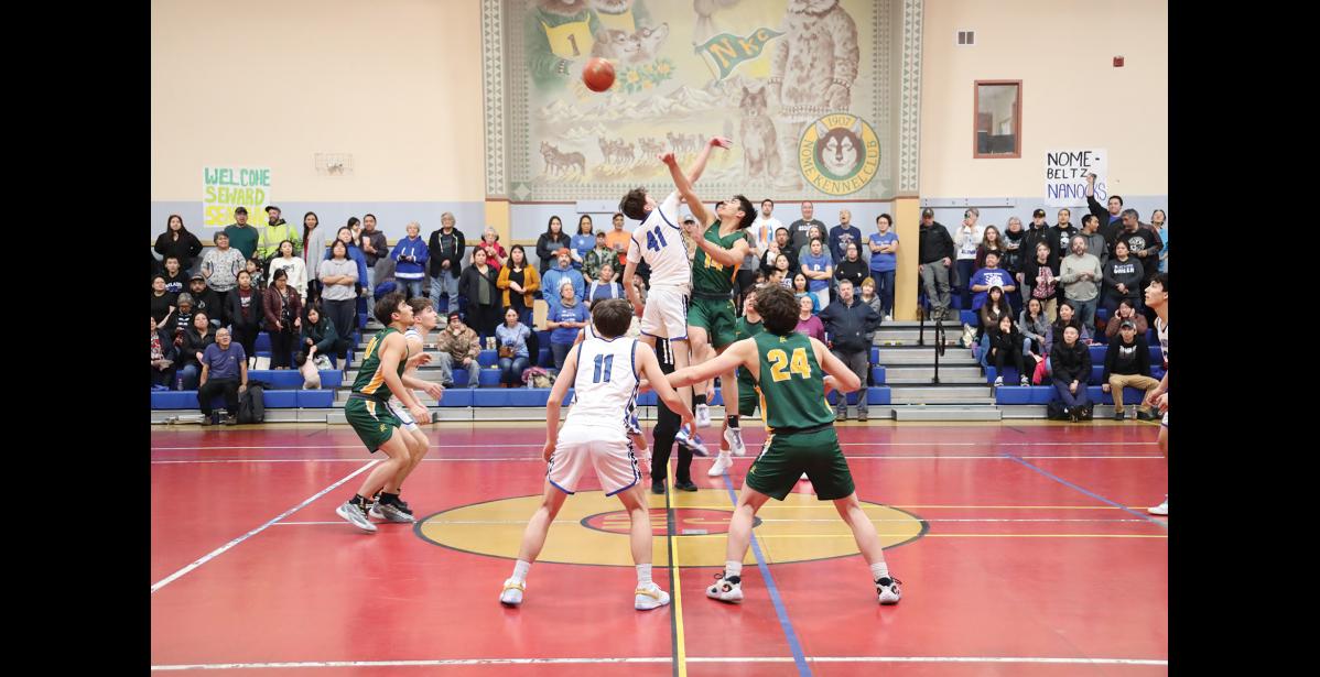 Photo by Anna Lionas JUMP- Nanook Cohen Booth and Seahawk Ben Ambrosiani jump for the ball to start the game.