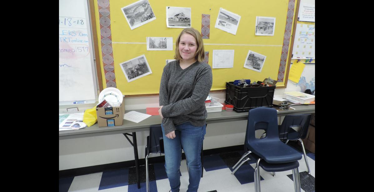 Photo by Amanda Tördal RECORDING HISTORY - Jenae Matson stands in Colleen Johnson’s classroom at Anvil City Science Academy. Students in Mrs. Johnson’s Social Studies class completed a project recording interviews with community members recalling important events or topics in Nome’s history. Matson interviewed her father, Tony Matson, regarding the "Friendship Flight” of 1988 when Alaska Airlines flew to Provideniya, Russia.