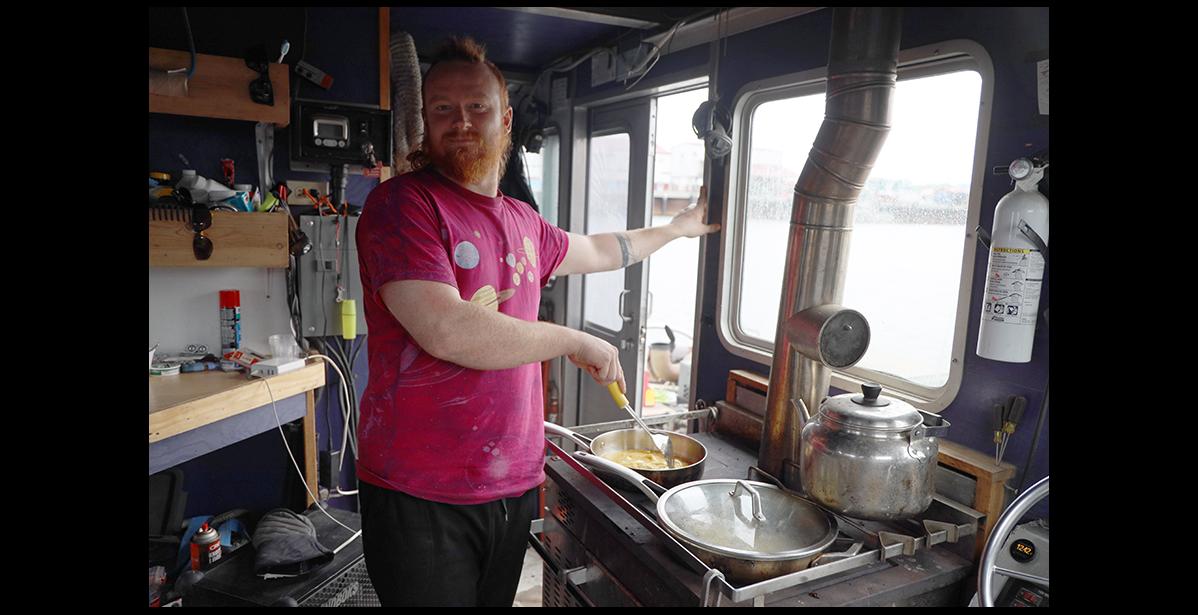 Photo by Colin Warren COOK – Sam Tenhoff whips up breakfast for his family crew on the gold dredge Synergy.