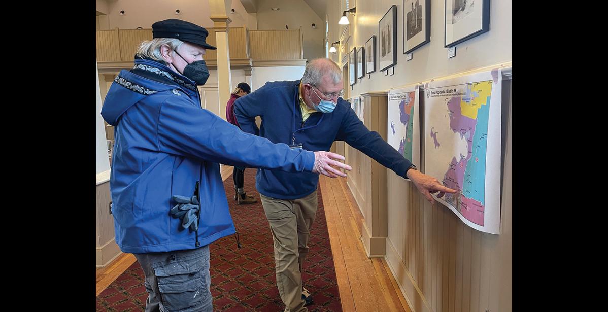 Photo by Julia Lerner Nomeite Lew Tobin, left, discusses a map proposal with Redistricting Board member Budd Simpson, during Monday’s public meeting at Old St. Joe’s.