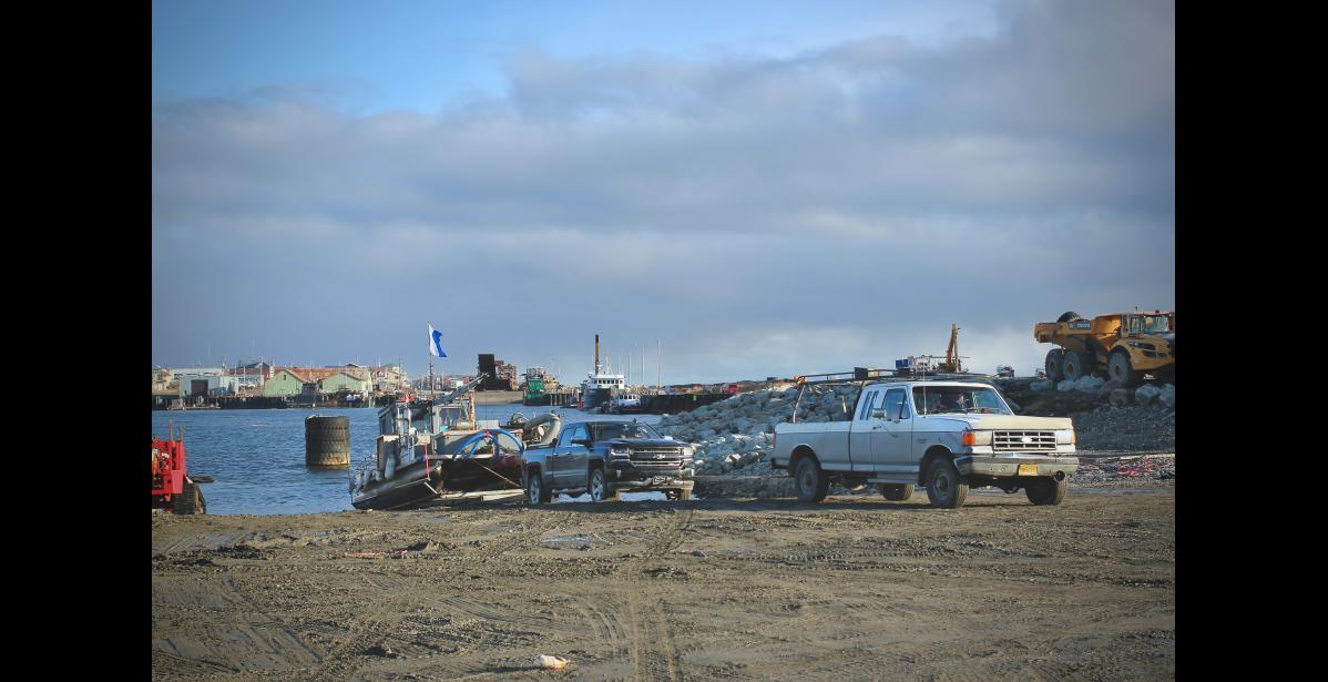 Photo by Jenni Monet A stranger uses his truck to help pull up one of the few remaining boats from the inner harbor, Friday. Port of Nome officials say most mariners departed the Bering Strait region by Wednesday, while others who missed the window made arrangements to shelter in place.