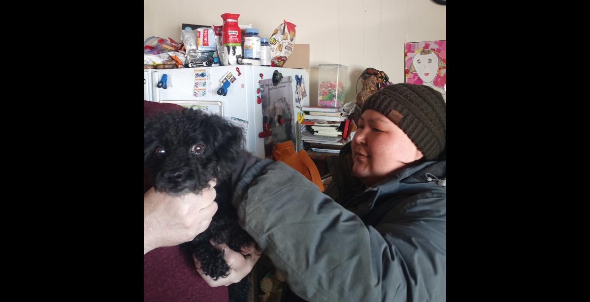 Photo by Jamie Oozeva VACCINATING— Chanelle Koonooka administers a distemper booster shot to a dog in Gambell on Monday.