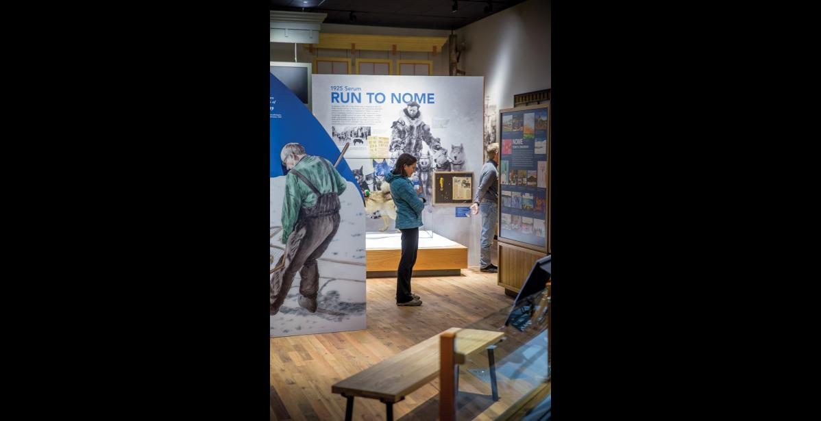 Photo by MIchael Burnett NEW MUSEUM— Museum visitor Carol Gales contemplates new exhibits at the reopening of the Carrie M. McLain Memorial Museum on Friday, Nov. 10.