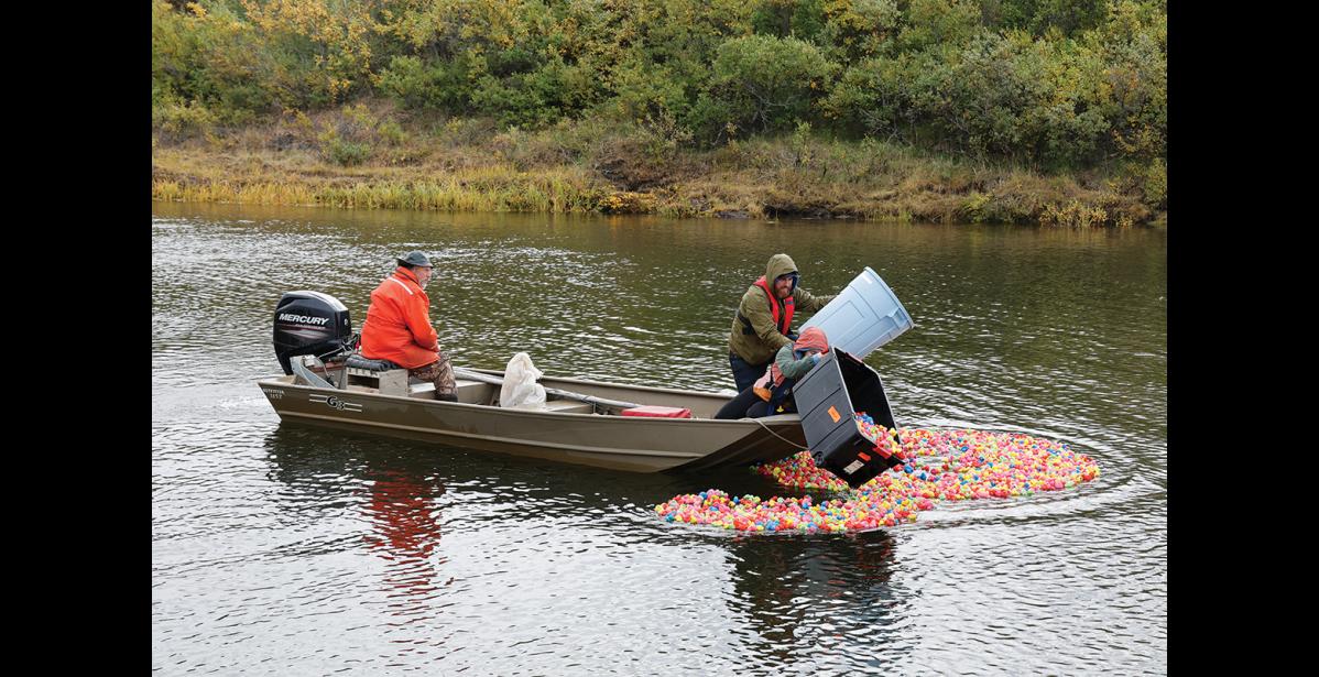 Photo by Megan Gannon READY — Charlie Lean, Nicole Santonastaso and David O’Neill release rubber duckies for the annual Rotary Rubber Duck Race in the Snake River.