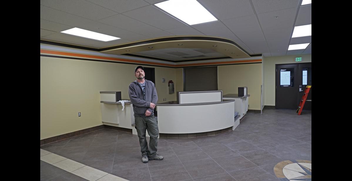 Photo by Megan Gannon WORK IN PROGRESS — Tyrel Johnson, general foreman for Alaska Commercial Development, poses inside the new lobby he’s been working on for Bering Air in the old Ravn hangar.