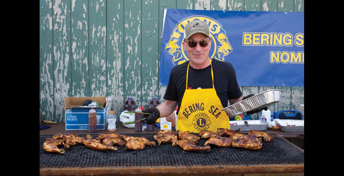 Photo by Nils Hahn Keith Conger tends to the grill at the Bering Sea Lions Club Chicken Feed.