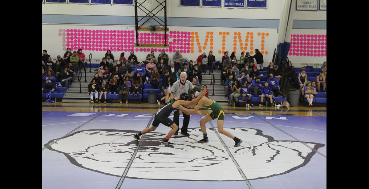 Photo by Peter Loewi NOME INVITE—Wrestlers from all over the region gathered last weekend in Nome to compete in the Nome Invitational wrestling meet. Here, wrestlers from Gambell and Brevig Mission start their match in front of a crowd in the den of the Nanooks.
