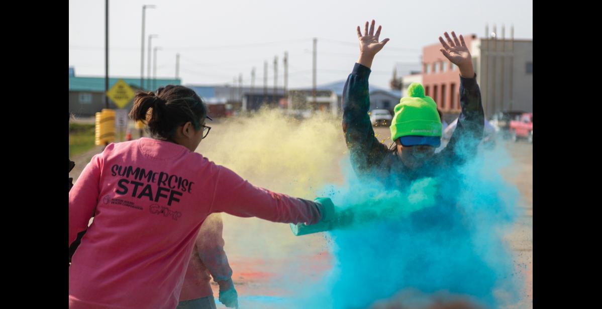 Photo by Sarah Manriquez Anna Ashenfelter raises her arms as she crosses the finish line and is showered in blue powder during the 2025 Color Run on Tuesday, June 17, 2025.