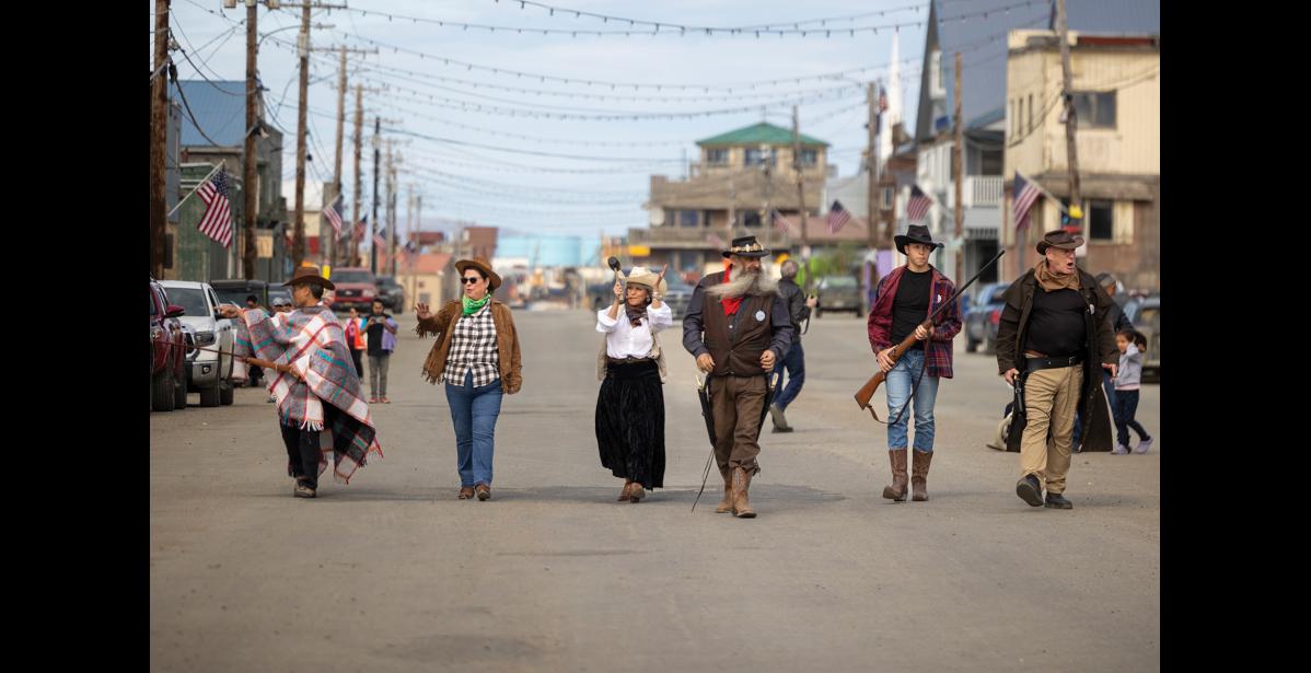 Photo by Sarah Manriquez Exactly at high noon, the outlaws made their entrance—bad guys in period dress striding dramatically down Front Street toward Wells Fargo Bank as part of Nome’s traditional solstice bank robbery reenactment. The mock heist, staged annually by the Nome Historical Society, harkens back to Nome’s gold rush era.