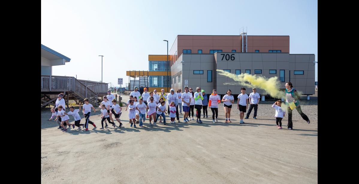Photo by Sarah Manriquez Runners take off from the starting line as Kara Ta, clinical associate and prevention specialist with BHS, shouts “Go!” and tosses yellow pigmented powder into the air during the 2025 Color Run on Tuesday, June 17, 2025.