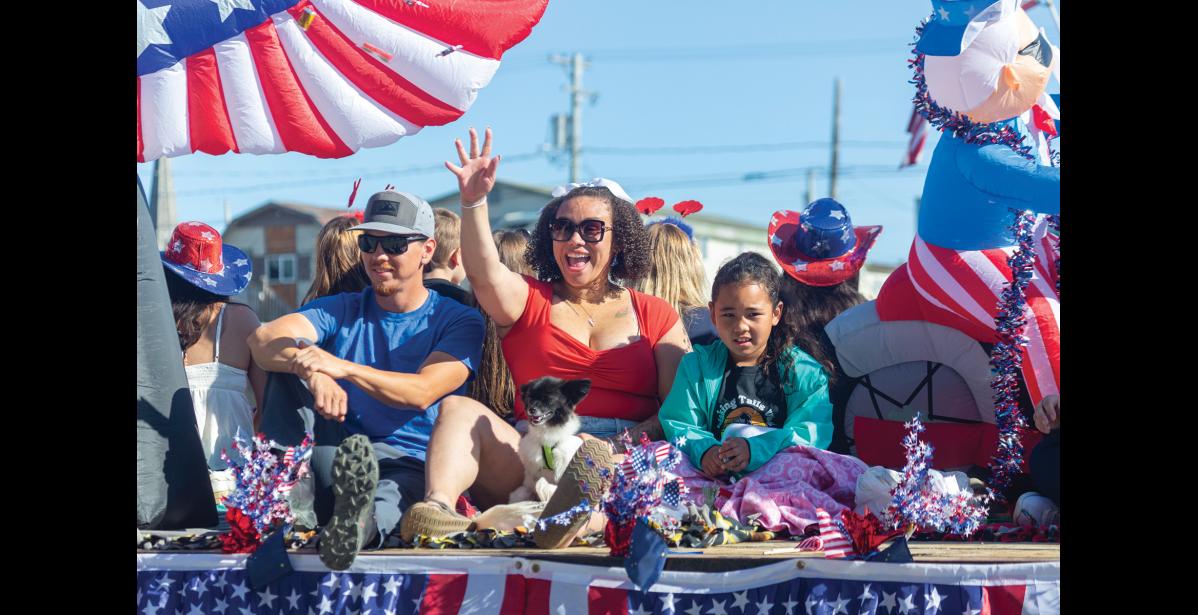 Photo by Sarah Manriquez CELEBRATING— Mackenzie Cabrera waves to familiar faces from a Fourth of July parade float with her daughter, Bianca Raleigh Cabrera, during Nome’s Independence Day celebration on Friday, July 4, 2025.