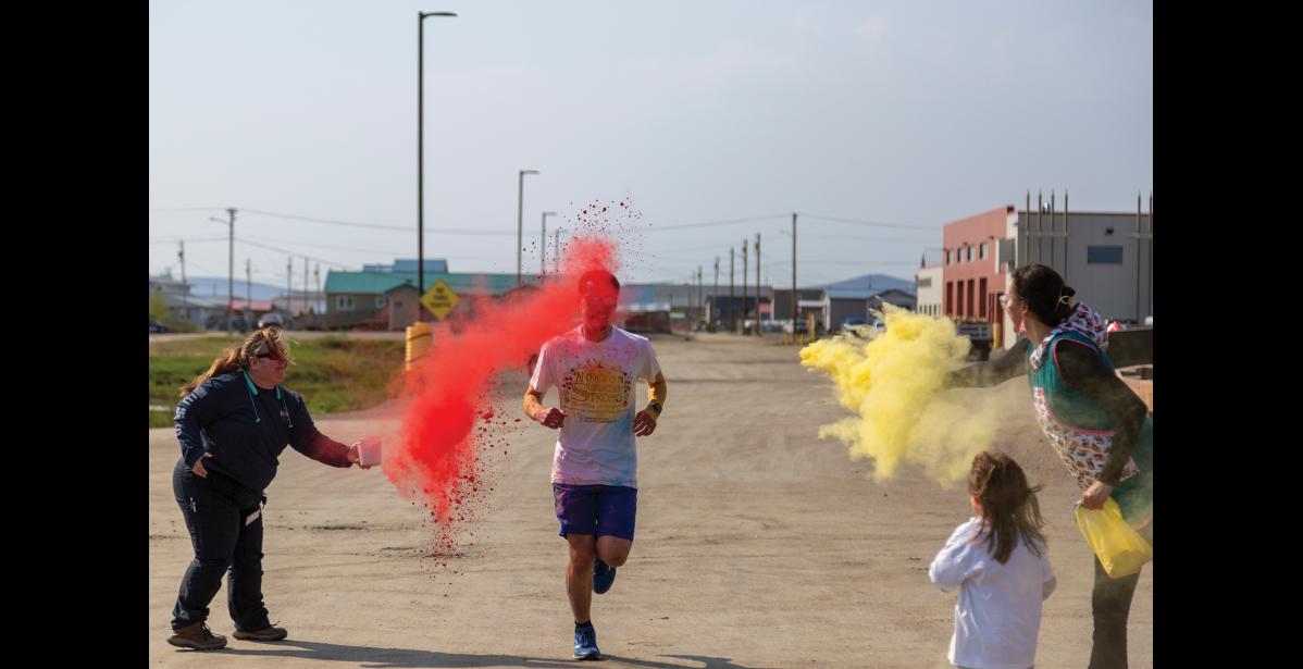 Photo by Sarah Manriquez Nome resident Harrison Moore crosses the finish line first, clocking a time of 5:58 for the one-mile course on Tuesday, June 17, 2025.