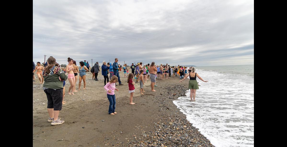 Photo by Sarah Manriquez Participants line the Bering Sea shoreline, bracing for the icy waters of the annual Polar Bear Plunge, sponsored and organized by the Nome Rotary Club during Nome’s Midnight Sun Festival on Saturday, June 21, 2025.