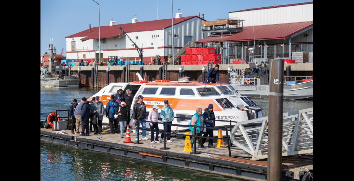 Photo by Sarah Manriquez VISITING NOME—Cruise ship passengers disembark a Westerdam tender with help from crew members at the Nome port for a day of local tours and events on Thursday, June 19, 2025.