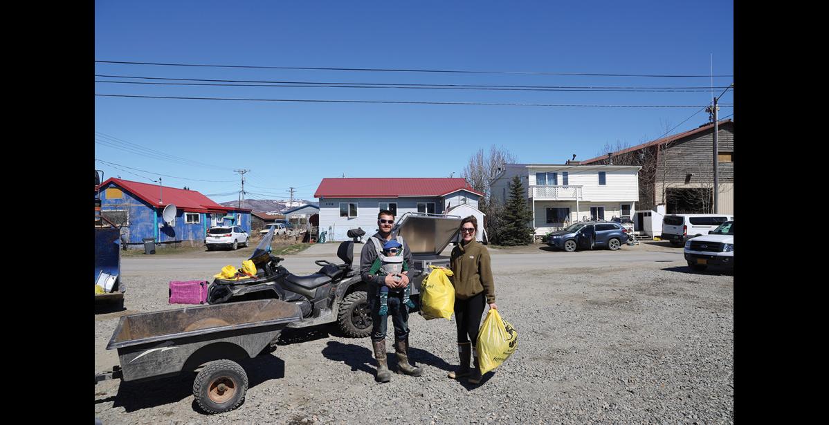 Photo by Colin Warren ELPING HAND – Jordan, Jett and Chelsea Miller drop off their yellow garbage bags to pitch in with Cleanup day