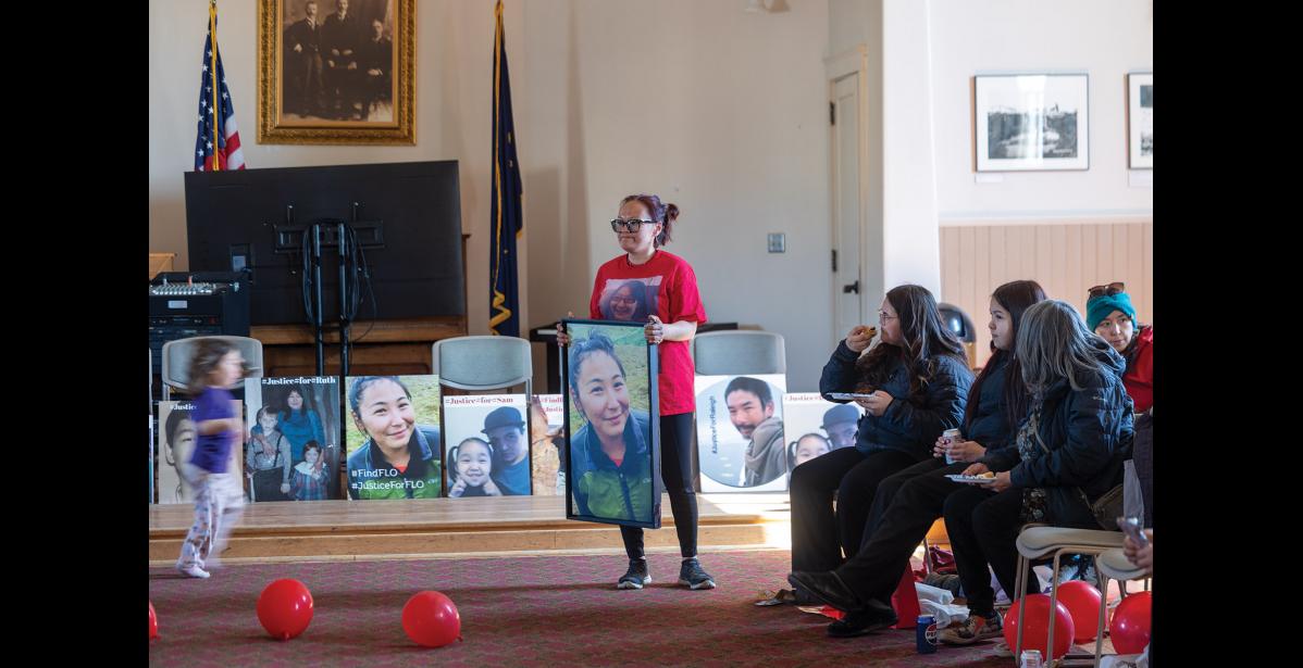Photo by Ariana Crockett O’Harra MISSING SISTER— Blaire Okpealuk shows the attendees gathered at Old St. Joe’s at the Missing and Murdered Indigenous People’s Day vigil on Tuesday, May 5 a picture of her sister Florence Okpealuk, who has been missing since 2020.