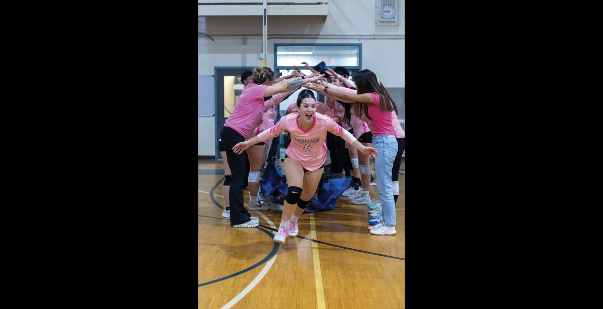 OUT OF THE TUNNEL – Sage Gregg runs onto the court at the start of the Nanooks’ match against Kotzebue during the Arctic Pinkies tournament on Friday, October 16 at Nome-Beltz Middle High School. Photo by Ariana Crockett O’Harra