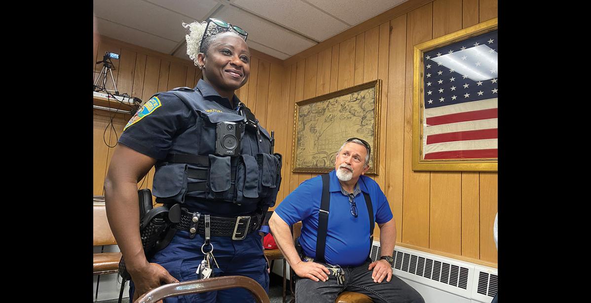 Photo by Diana Haecker LOVING NOME— Nome Police Chief Mike Heinzelman (seated) introduced NPD officer Wanga Kinuthia to the City Council. Originally from Kenya, she said she came to the US on a rugby scholarship and later got into law enforcement. She loves it here in Nome and is excited to be part of NPD to work on improving community relations.