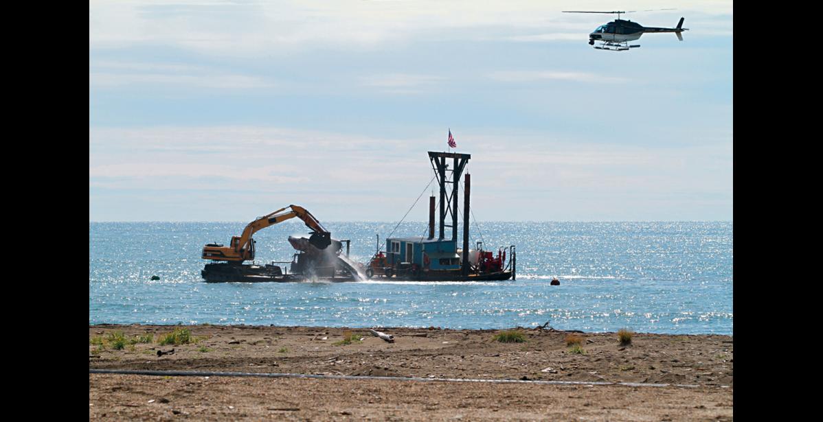 Nome Nugget file photo/ Diana Haecker GOING BIG— The Pomrenkes’ gold dredge Christine Rose is digging for gold off Nome’s beaches, as a film crew in the helicopter is filming the action in this file photo from 2011.