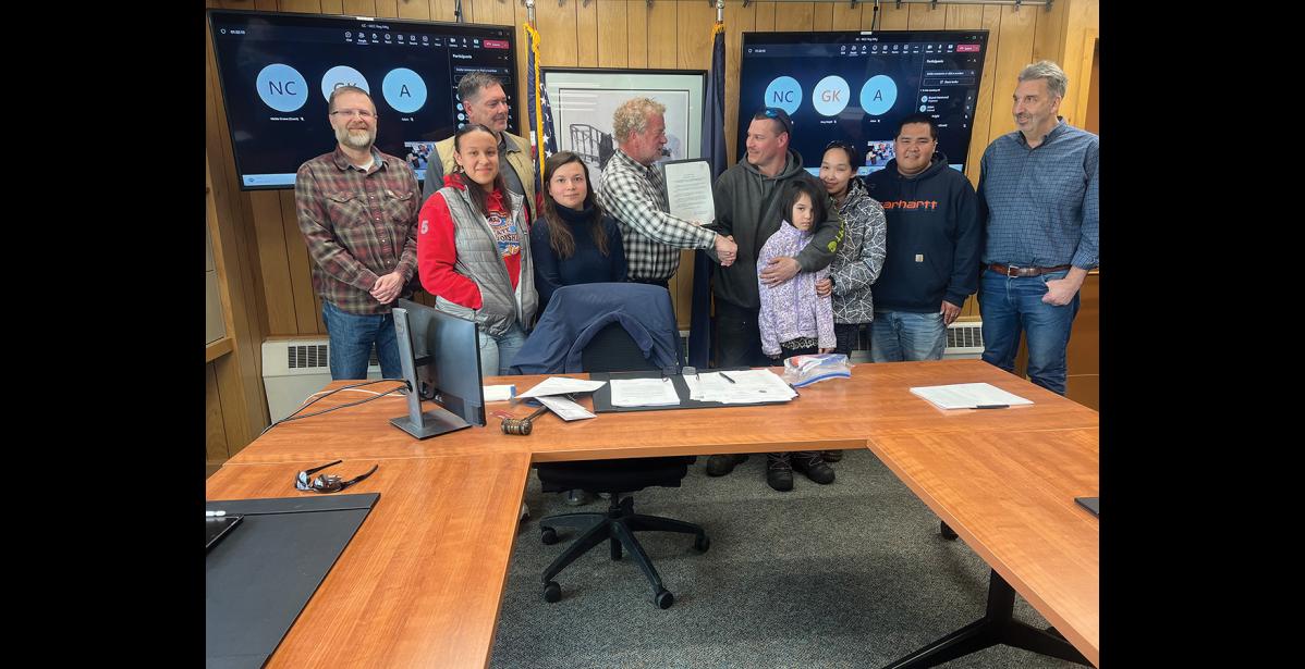 Photo by Diana Haecker COMMENDATION— Mayor John Handeland and the Nome Common Council commended Michael Hahn on his quick actions that saved the Public Works building from further fire damage, on March 11. Pictured are council members Scot Henderson, Doug Johnson, youth representative Kelly Miller, Sigvanna Tapqaq, Mayor John Handeland, Michael Hahn and his family, Cameron Piscoya and Mark Johnson.