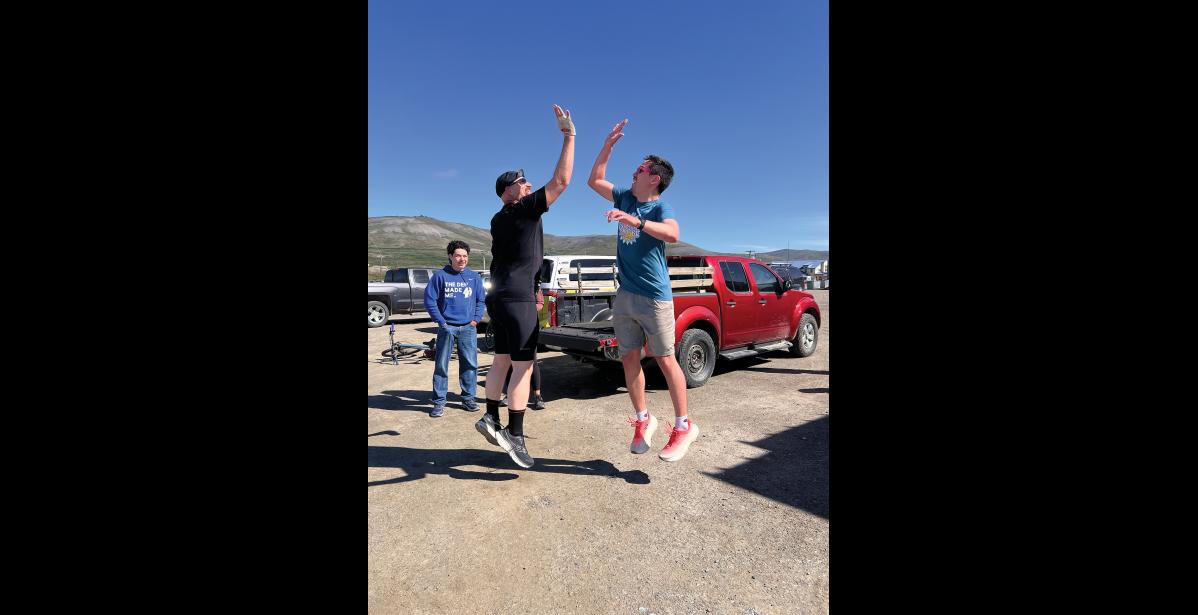 GOOD SPORTS— Rolland Trowbridge and Harrison Moore high-fived after completing the Stroke-n-Croak triathlon, as swimmer Lathen Ahmasuk looks on. Photo by Diana Haecker