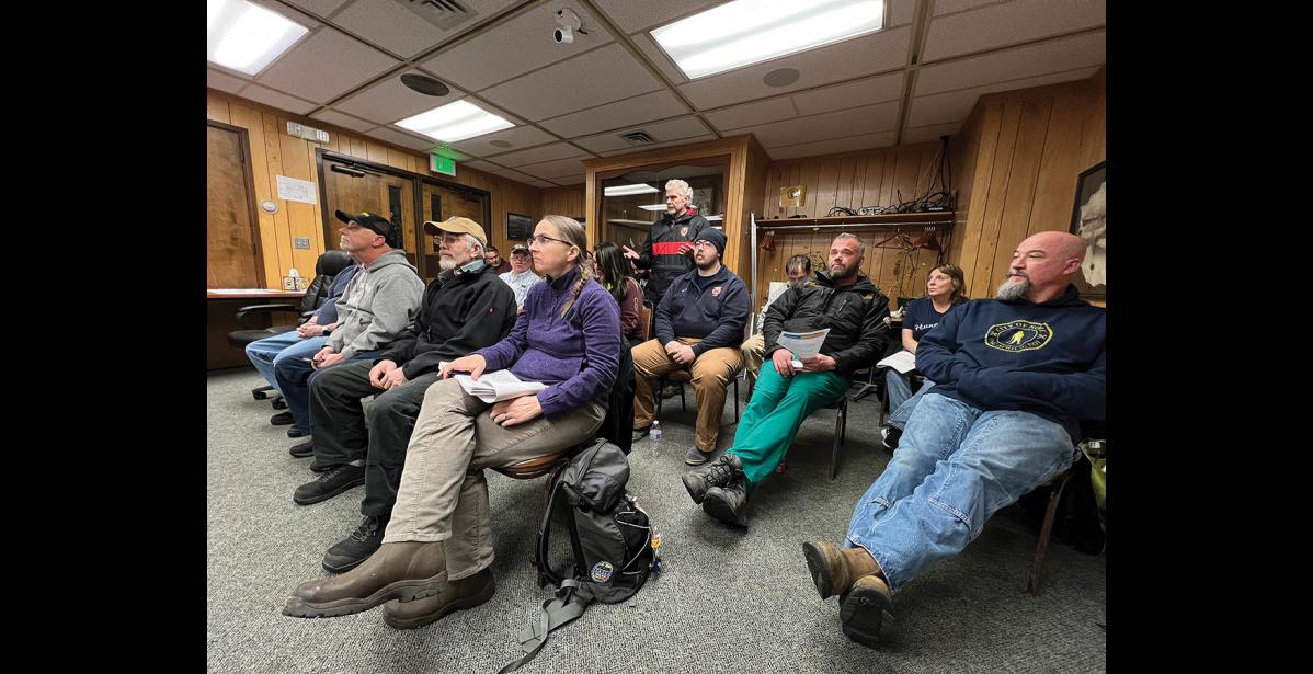 Photo by Diana Haecker AMBULANCE— Nome Volunteer Ambulance Department Chief Jim West Jr., standing, addresses the Nome Common Council as council members weighed their decision to retain or relinquish the ambulance service