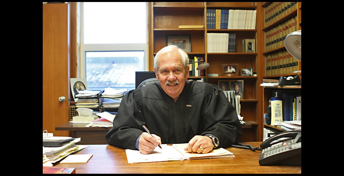 Nome Nugget file photo by Diana Haecker Superior Court Judge Ben Esch at his desk in Nome shortly before retiring in January 2013.