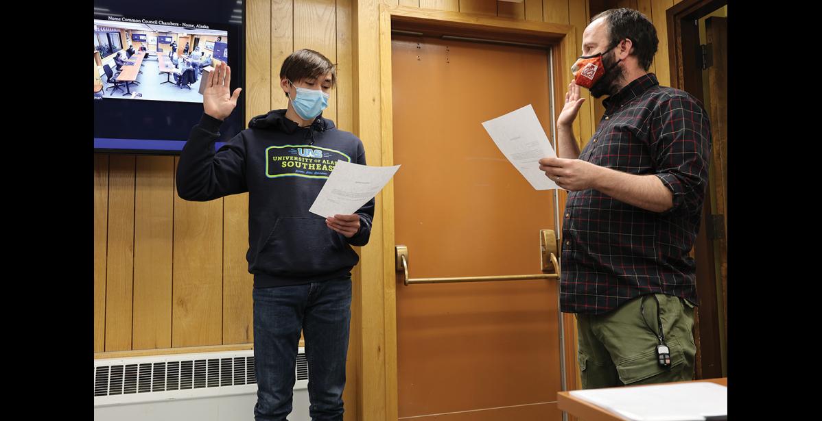 Photo by Diana Haecker SWORN IN— City Clerk Bryant Hammond, right, swears in Paris Hebel as the new Youth Representative on the Nome Common Council.