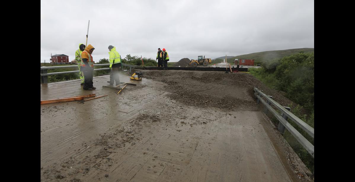 Photo by Diana Haecker SNAKE RIVER BRIDGE— On Monday, July 21, DOT workers began the process of building a temporary bridge as the current one is slanted severely, rendering it unsafe for passage, especially in icy conditions.