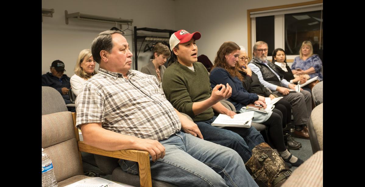 Photo by James Mason ROAD TO AMBLER— The Northwest Arctic Borough’s John Chase, in hat, makes a point at the Ambler Road scoping meeting Wednesday, Dec. 6 in Kotzebue. In foreground is Hiram Walker. The federal Bureau of Land Management is holding scoping meetings for an EIS in the region.