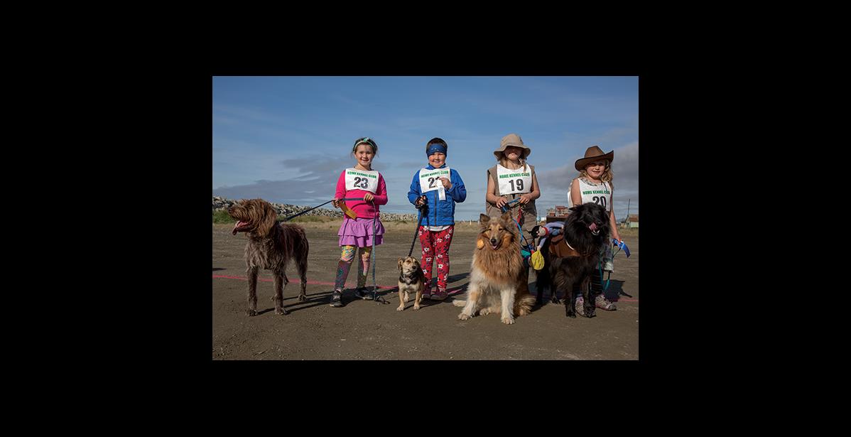 Photo by James Mason NOME DOG FAIR— The Nome Kennel Club held its first Dog Fair on Saturday, Aug. 24 outside the Mini Convention Center in Nome. Kids and their dogs had a grand time, as evidenced by the smiles of winners in the Kid’s Dash: (left to right) Nevelo Hoogendorn and Ruby, Kathrynne Dixon and Gidget, Amelia Richards and Winter, and Rosalie Richards with Tikaani.
