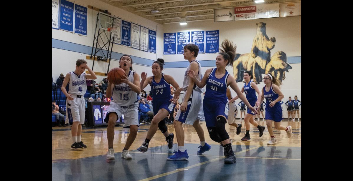 Photo by James Mason TAKE THE SHOT – JV Nanook Jon Smith lines up a shot in action against the Lady Nanooks during Saturday’s basketball games.