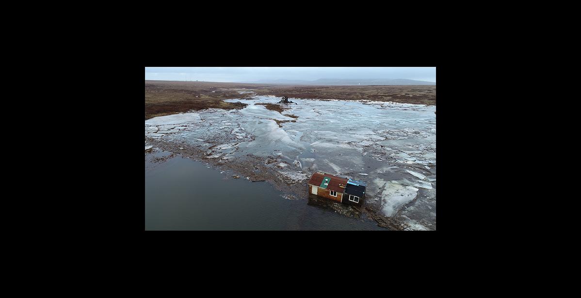 Photo by James Mason The Hukill cabin was washed upriver and rests about half a mile upriver from the Nome River bridge.