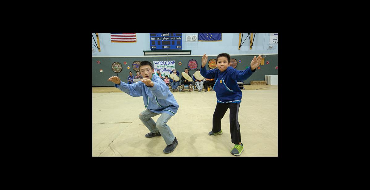 Photo by James Mason TELLER CULTURAL FESTIVAL— Shishmaref dancers Kenny Iyatunguk, left, and Gavin Nayokpuk entertain the crowd at last weekend’s Teller Cultural Festival. See story and photos on pages 8/9.