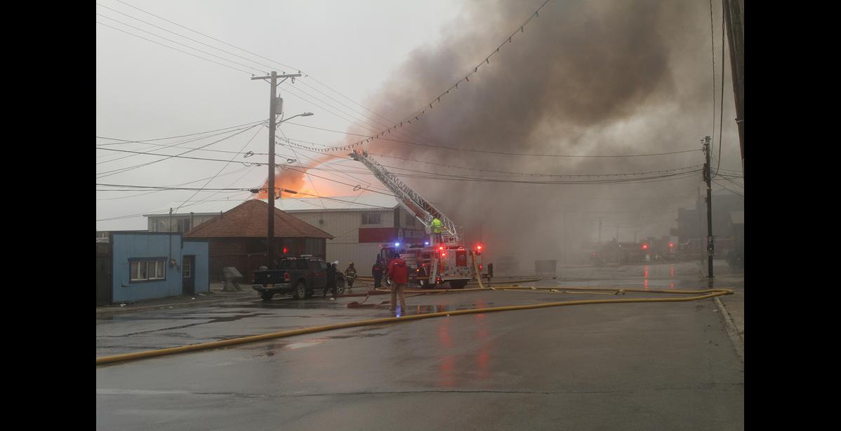 Photo by Peter Loewi BERING SEA FIRE— In the midst of the storm, NVFD volunteers fought a fire that claimed the Bering Sea Restaurant and Bar entirely. Three people were treated for injuries, one dog perished in the fire.