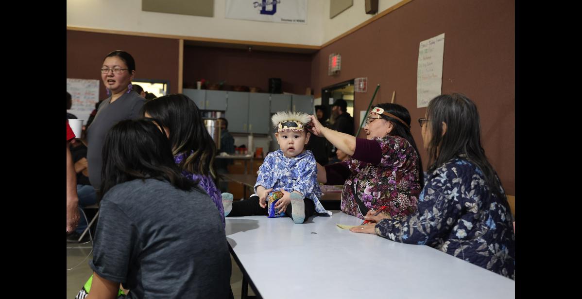 Photo by Megan Gannon GETTING READY — Jolie Koonooka prepares for Gambell’s turn to perform with the help of her grandma Shem Rose Koonooka.
