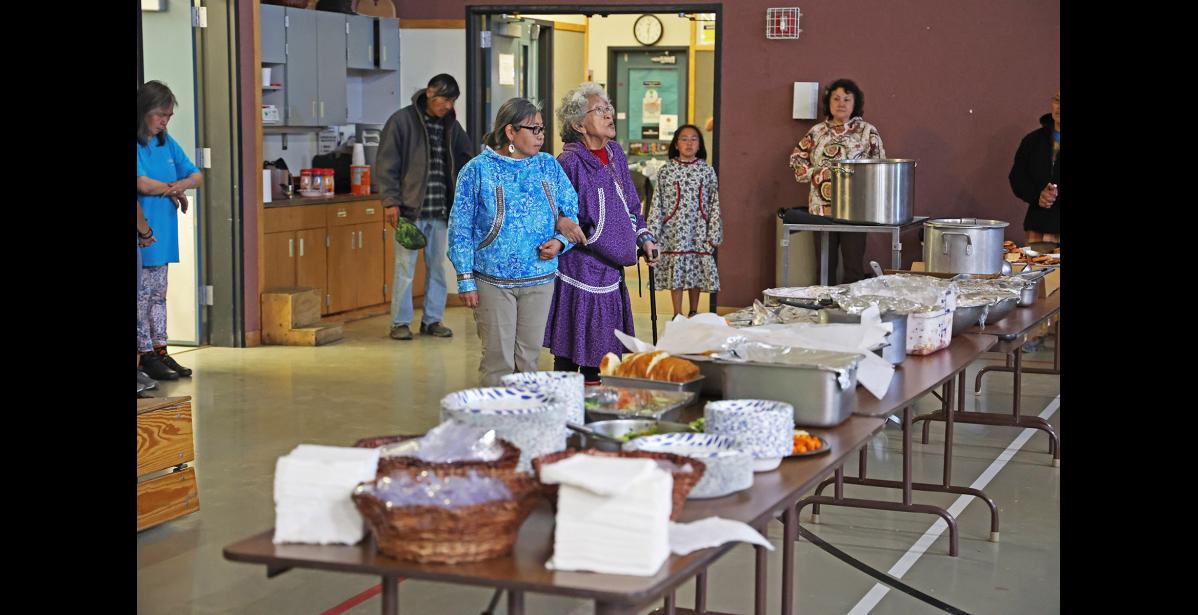 Photo by Megan Gannon BLESSING — Sophie Nothstine blessed Sunday’s feast while Leah Canfield offered support.