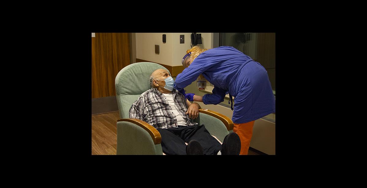 Photo courtesy NSHC FIRST COVID VACCINE IN NOME— Phillip Dexter, 96, was the first QCC resident to receive the COVID-19 vaccine on Wednesday, Dec. 16. The vaccine was administered by Marla Mayberry, LPN.