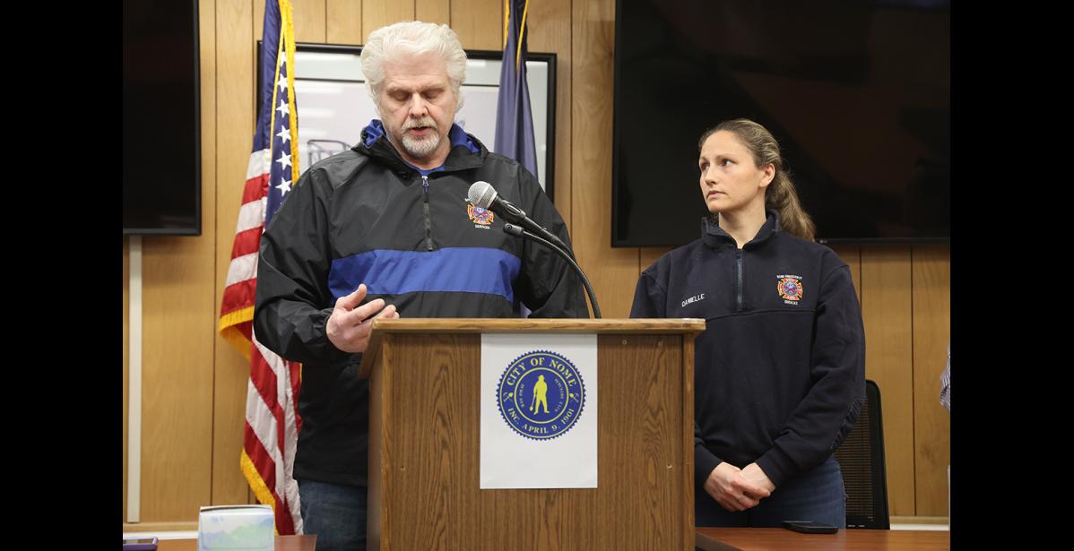 Photo by Anna Lionas Nome Volunteer Fire Department and SAR Chief Jim West Jr. reports on recovery efforts, as NVFD spokesperson Danielle Sem looks on.