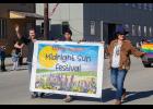 Photo by Julia Lerner MIDNIGHT SUN— Making a nearly 24-hour appearance was the midnight sun, rewarding Midnight Sun Festival organizers Drew McCann, left, and Briday Green, right, with perfect weather for Saturday’s activities, kicking off with a parade. Also pictured is Brandon Rose.