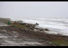 Photo by Nils Hahn STORMY— Gold mining dredges were brought up high as high surf pounded East Beach on July 28, setting the all-time rain record for that day with a precipitation of 1.47 inches.