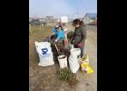 HARD AT WORK— Cheryl Thompson and Kim Knudsen readying a dredge bucket for flowers. Photo courtesy Angela Hansen