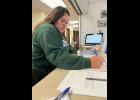 Photo by Diana Haecker RUNNING FOR OFFICE— Maggie Miller submits her paperwork to run for Nome Common Council Seat B.
