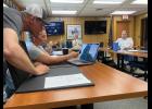 Photo by Diana Haecker MINING PERMIT— Councilwoman Jennifer Reader confirms with Shawn Pomrenke of Northwest Gold Diggers where he plans to mine for gold within the Moonlight Wells Protective area, during Tuesday’s Nome Common Council meeting.