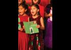 SING IT! – Second graders Hannah Harrelson and Violet Fagundes add their voices to Christmas Card during last week’s Nome Elementary Holiday Program. 